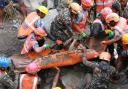 In this photo provided by the Nepal Army, soldiers rescue a worker alive from a tunnel during an ongoing operation at the Trishuli-3A hydropower project in Nepal's Rasuwa district, Friday, Sept. 4, 2026. (Nepal Army via AP)