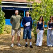 Students at Manningtree High School celebrating their GCSE results with head of Year 11 Mr Walker