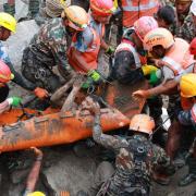 In this photo provided by the Nepal Army, soldiers rescue a worker alive from a tunnel during an ongoing operation at the Trishuli-3A hydropower project in Nepal's Rasuwa district, Friday, Sept. 4, 2026. (Nepal Army via AP)