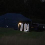 Police have exhumed a body from a burial ground near Whitchurch as part of an investigation into the death of a woman in 2022